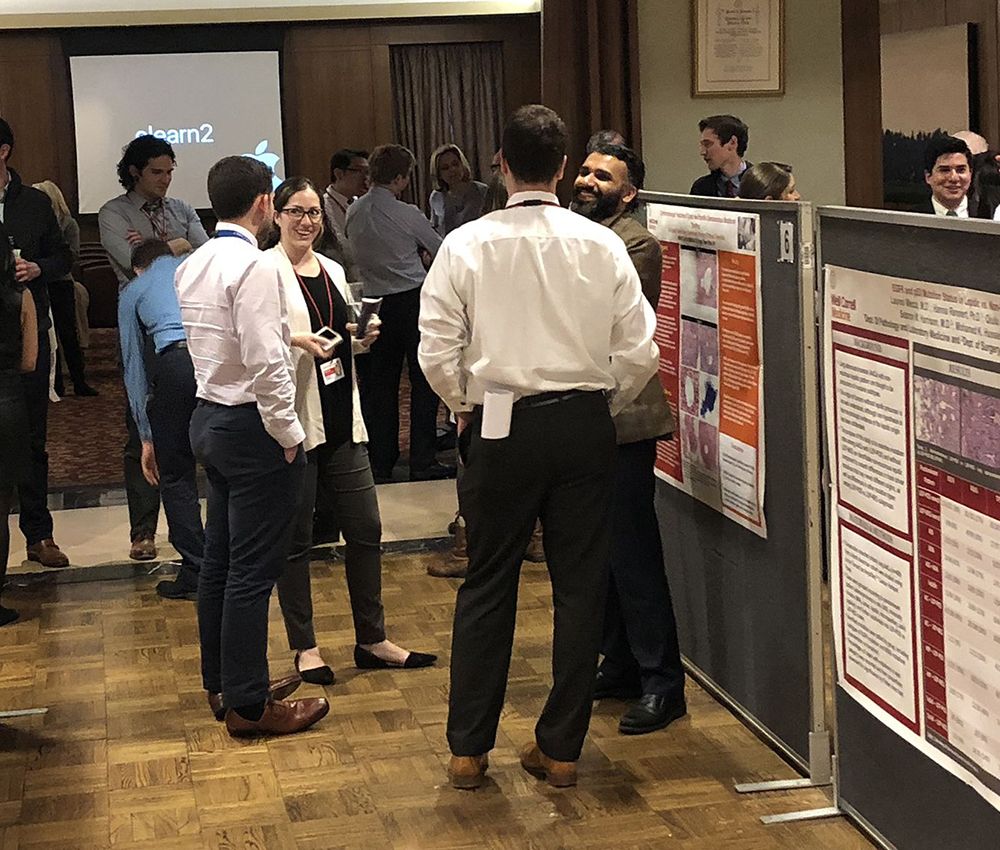 Faculty and residents mingling at Resident Research Day 2018