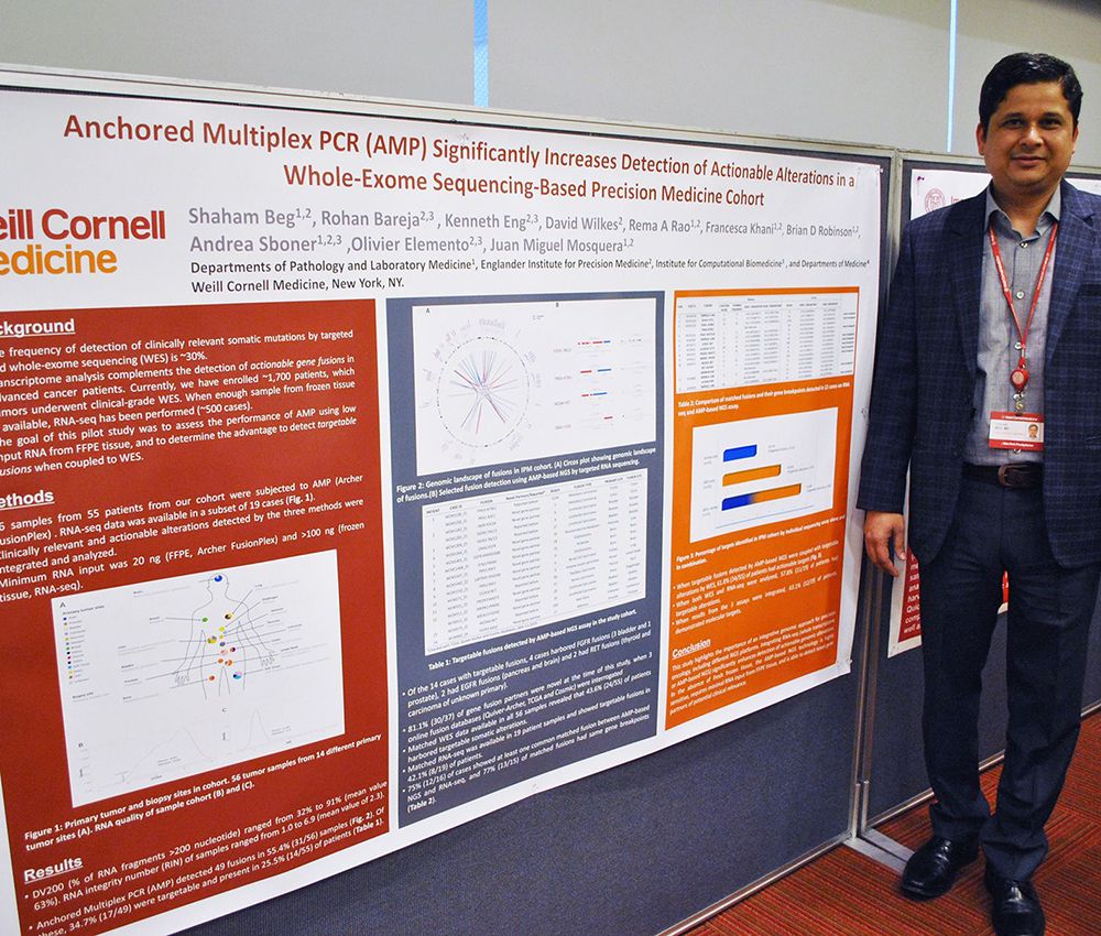 Shaham Beg, M.D., with his poster.